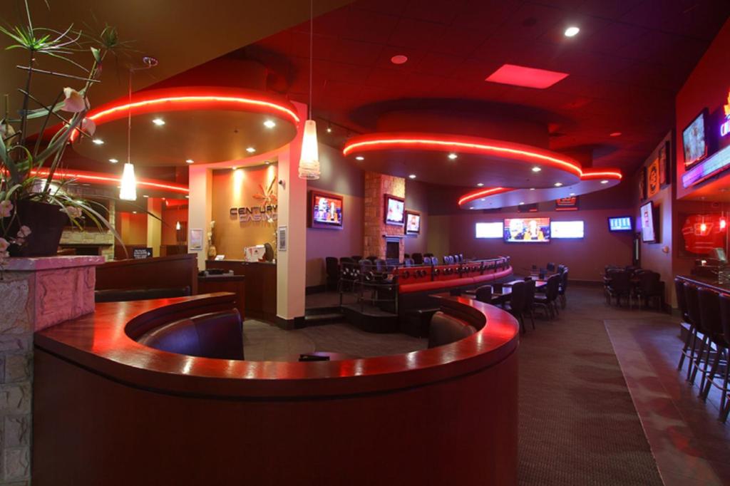 a bar with tables and chairs in a restaurant at Century Casino & Hotel Edmonton in Edmonton