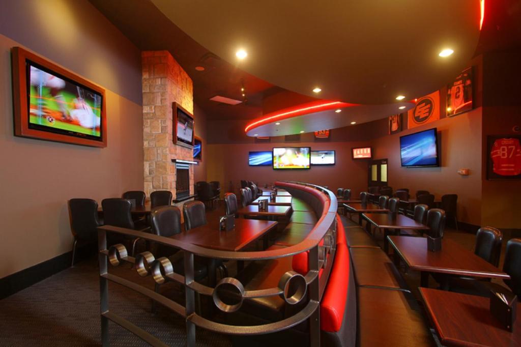 a dining room with tables and chairs and televisions at Century Casino & Hotel Edmonton in Edmonton