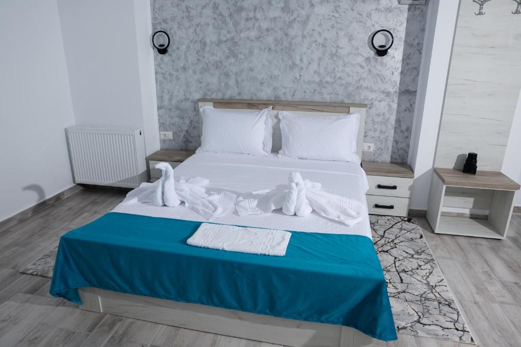 Postel nebo postele na pokoji v ubytování RUXO Hotel