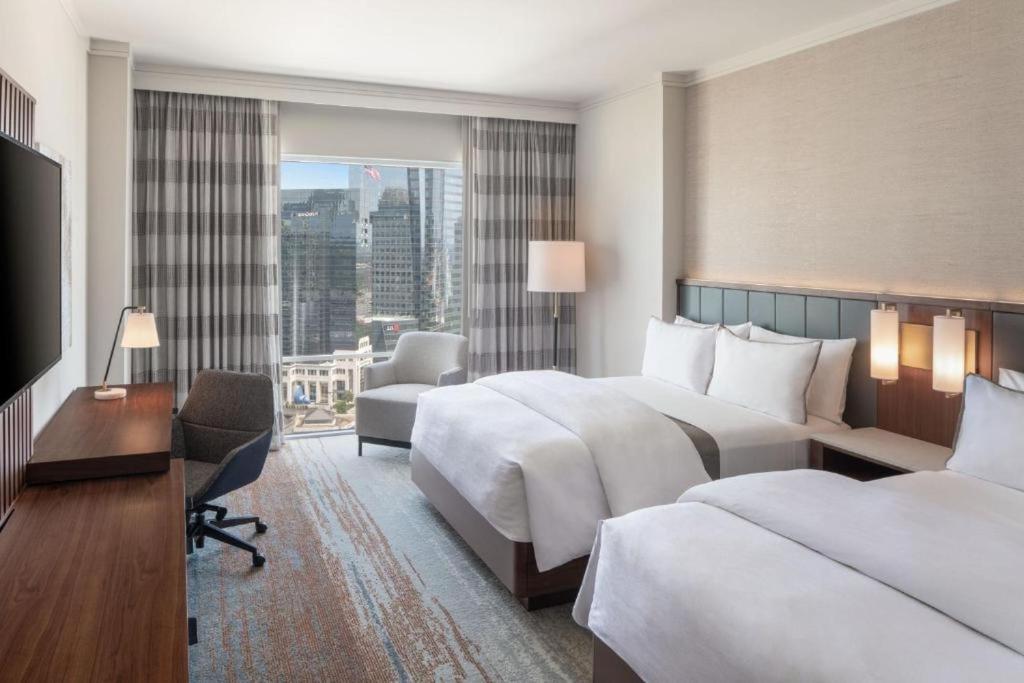 a hotel room with two beds and a television at The Westin Buckhead Atlanta in Atlanta