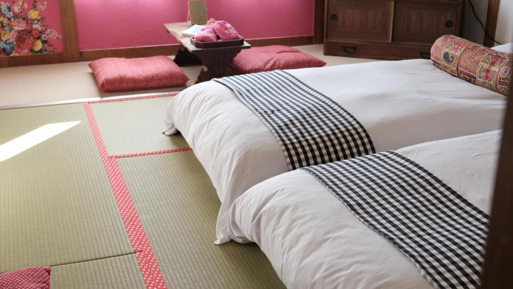 Guesthouse HOALOHA 4 SEASONSにあるベッド
