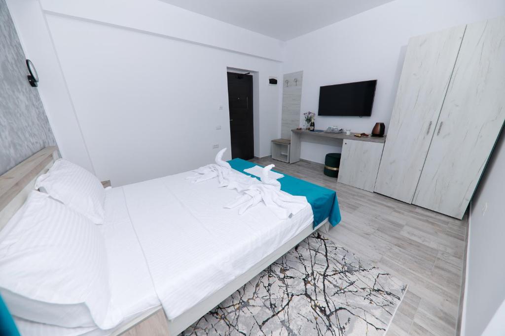 Postel nebo postele na pokoji v ubytování RUXO Hotel