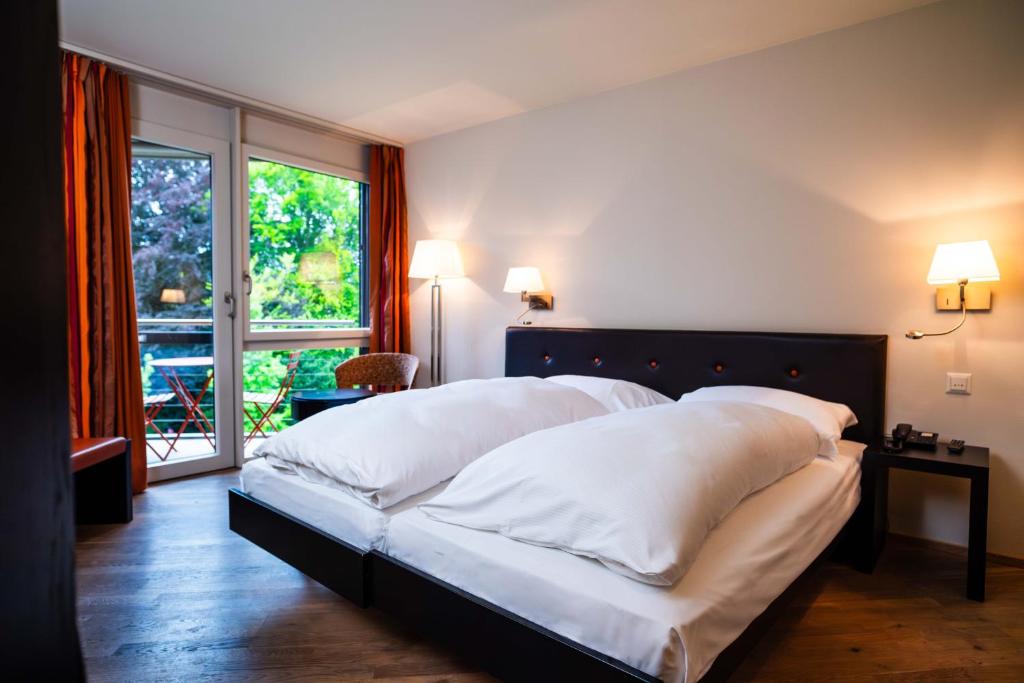 Voodi või voodid majutusasutuse Hotel Seepark Thun toas