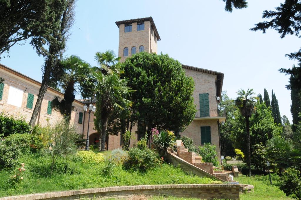 stary dom z wieżą na górze w obiekcie Relais Villa Sant'Isidoro w mieście Colbuccaro
