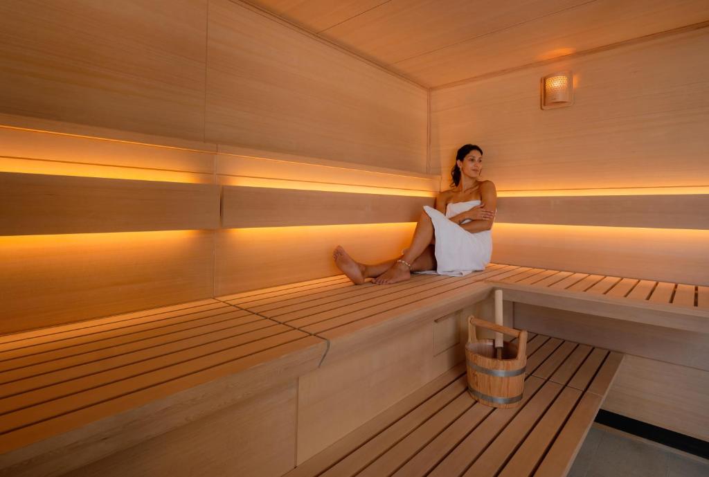 a woman sitting in the inside of a sauna at Hôtel Villa M Marseille in Marseille
