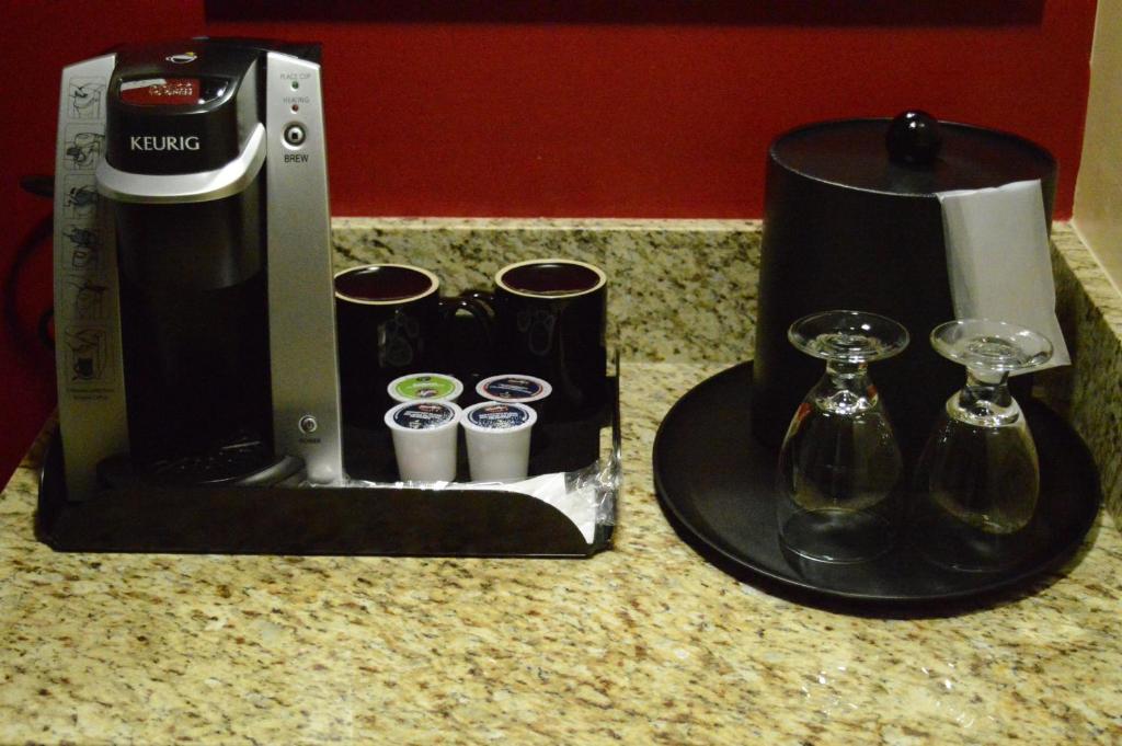 a coffee maker and glasses on a counter at Century Casino & Hotel Edmonton in Edmonton