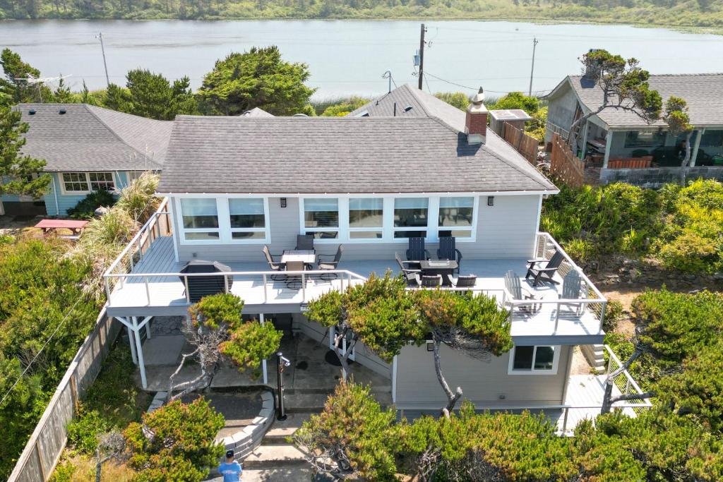 an aerial view of a white house with trees at Loki's Kingdom in Rockaway Beach