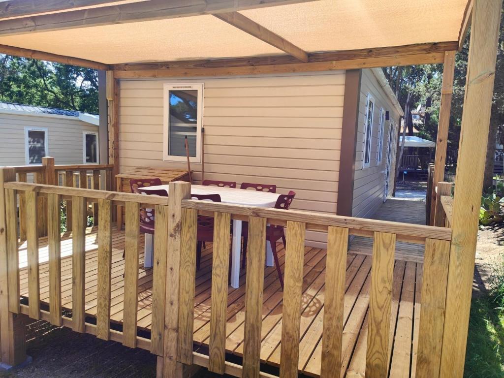 a wooden deck with a pergola on a house at Camping la Croix du Sud in Saint-Tropez