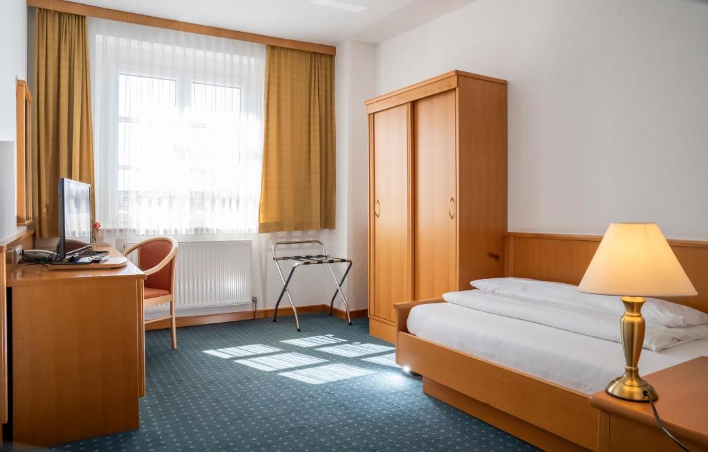 Postel nebo postele na pokoji v ubytování Eisenbock's Strasser Hof