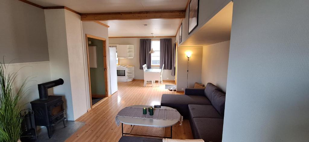 a living room with a couch and a stove at Storgata 78, Leknes sentrum in Leknes