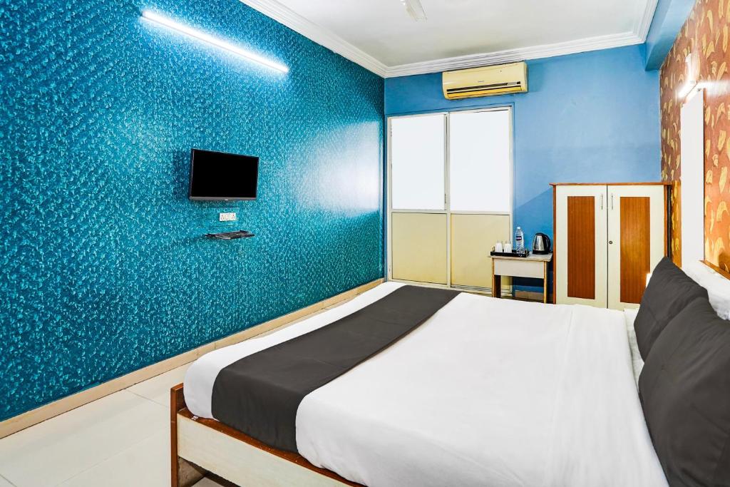Postel nebo postele na pokoji v ubytování Super Hotel O Vibrant Residency