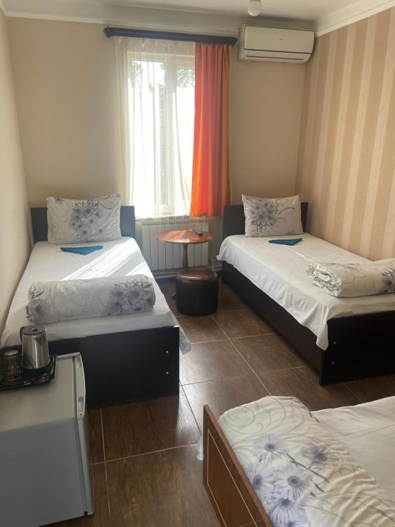 Postel nebo postele na pokoji v ubytování Zangu Hotel