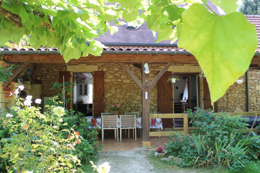 un patio d'une maison avec une table et des chaises dans l'établissement Zénitude, à Meyrals