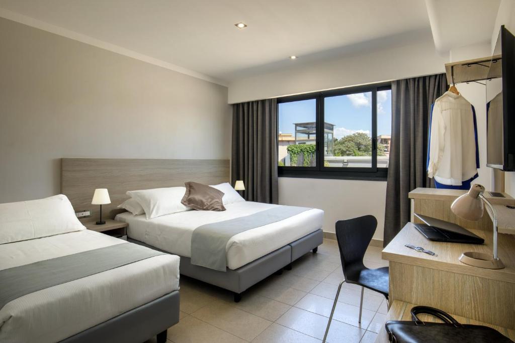Postel nebo postele na pokoji v ubytování Simon Hotel Aprilia