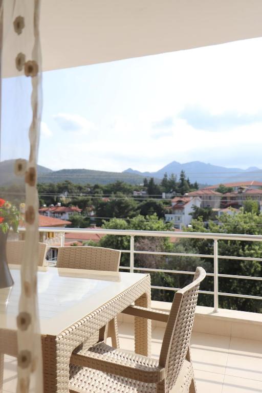 a table and chairs on a balcony with a view at Blackwood Flava Cora in Datca