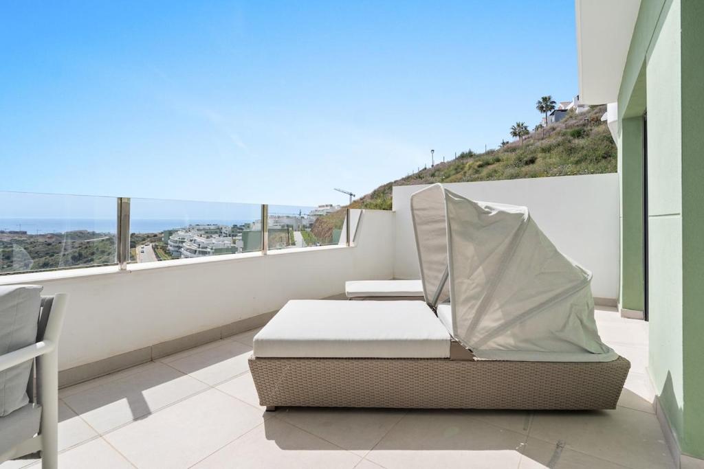 a balcony with a bed and a view of the ocean at Chic and stunning views on amazing terrace RDR484 in Mijas Costa