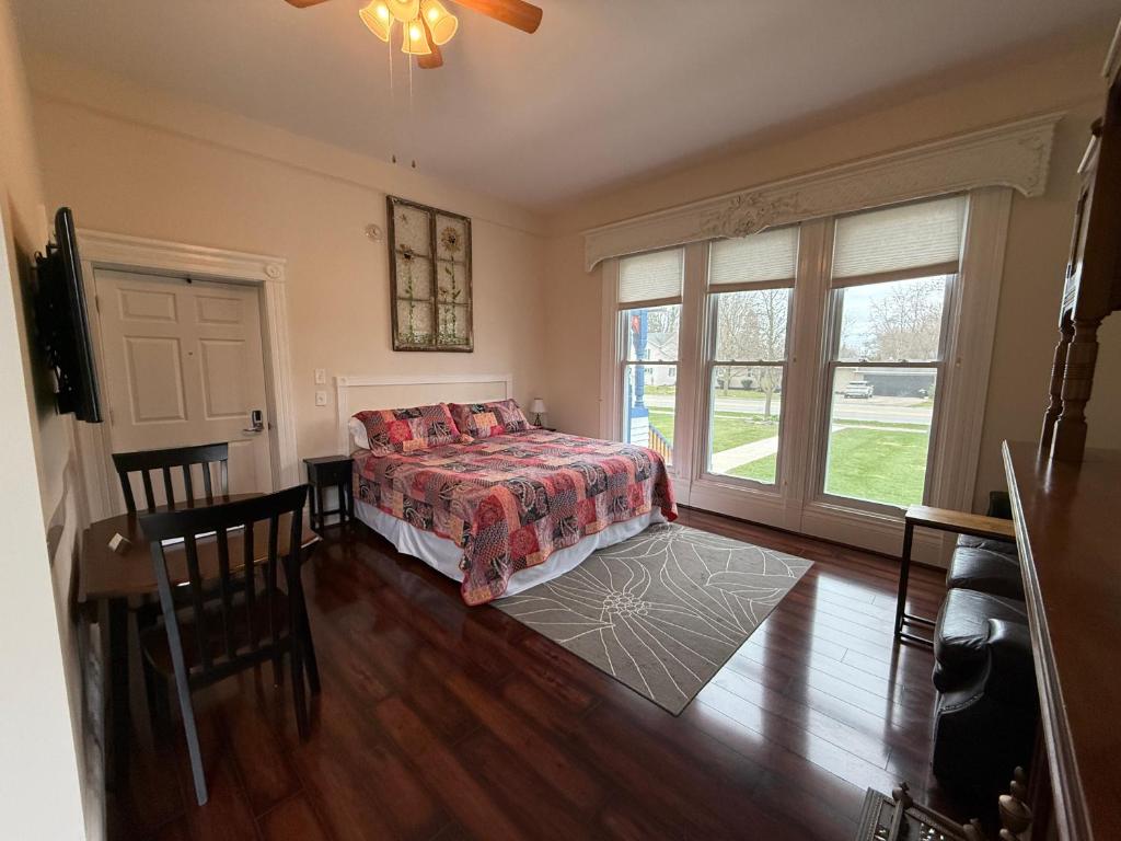 a bedroom with a bed and a table and chairs at Lake Huron Lodge in Lexington
