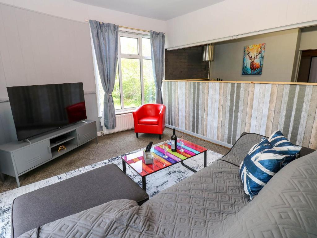 a living room with a couch and a television at Newfield Apartment in Bishop Auckland