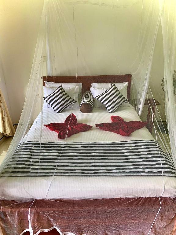 Postel nebo postele na pokoji v ubytování Liana Guest House Ella