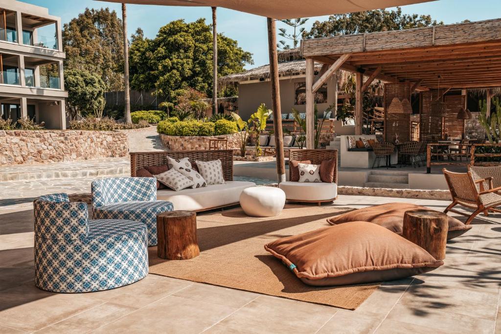 a patio with chairs and furniture on a rug at Sagredo Boutique Hotel & Spa in Ágios Fokás