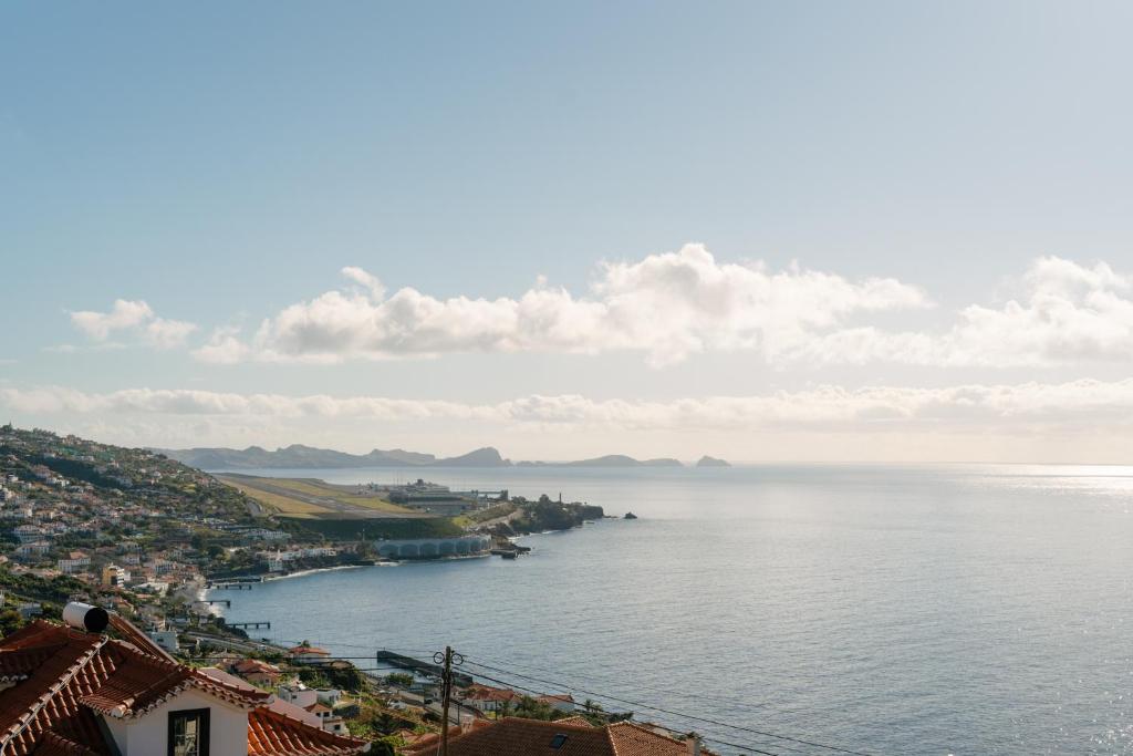 a view of a large body of water with houses at Sunrise House by Wanderlust Madeira - 2 Bedroom Sea View in Gaula