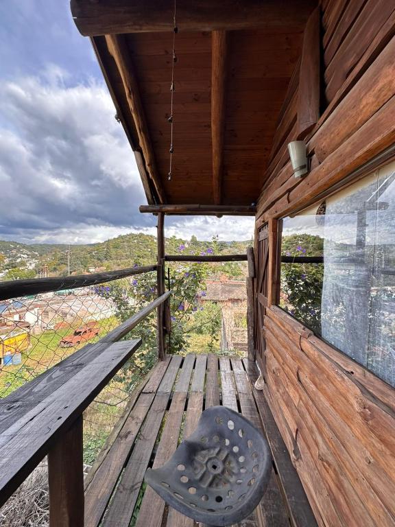 a view from the inside of a cabin with a bench on a deck at CABAÑA STANDARD pileta-cochera in Río Ceballos