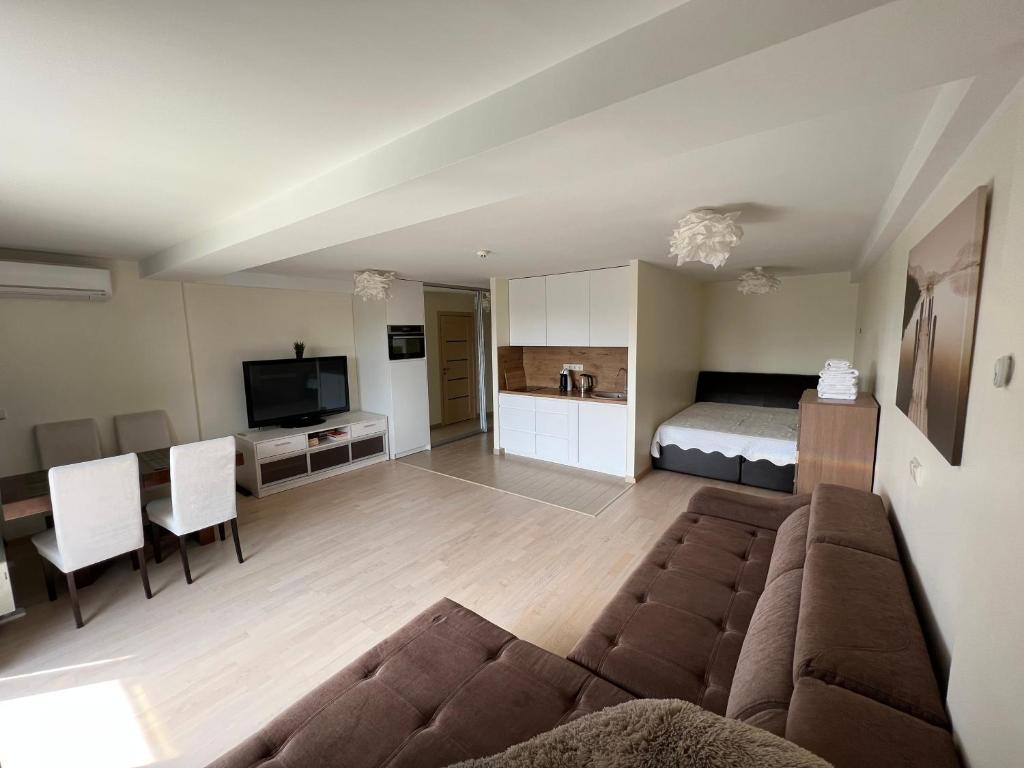 a living room with a couch and a bed at Palanga poilsiui in Palanga