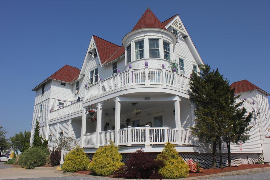 una grande casa bianca con portico e balcone di Tavern on the Bay Hotel - Meyer Lansky Suite a Somers Point
