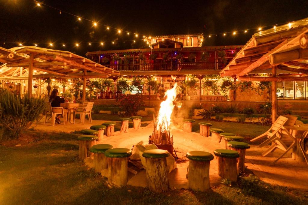 a fire pit in the middle of a patio at night at Jardin de los Silleteros Agro Parque Hotel in Santa Elena