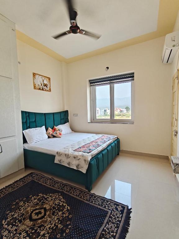 a bedroom with a bed and a window at Rawat's Oasis in Rishīkesh