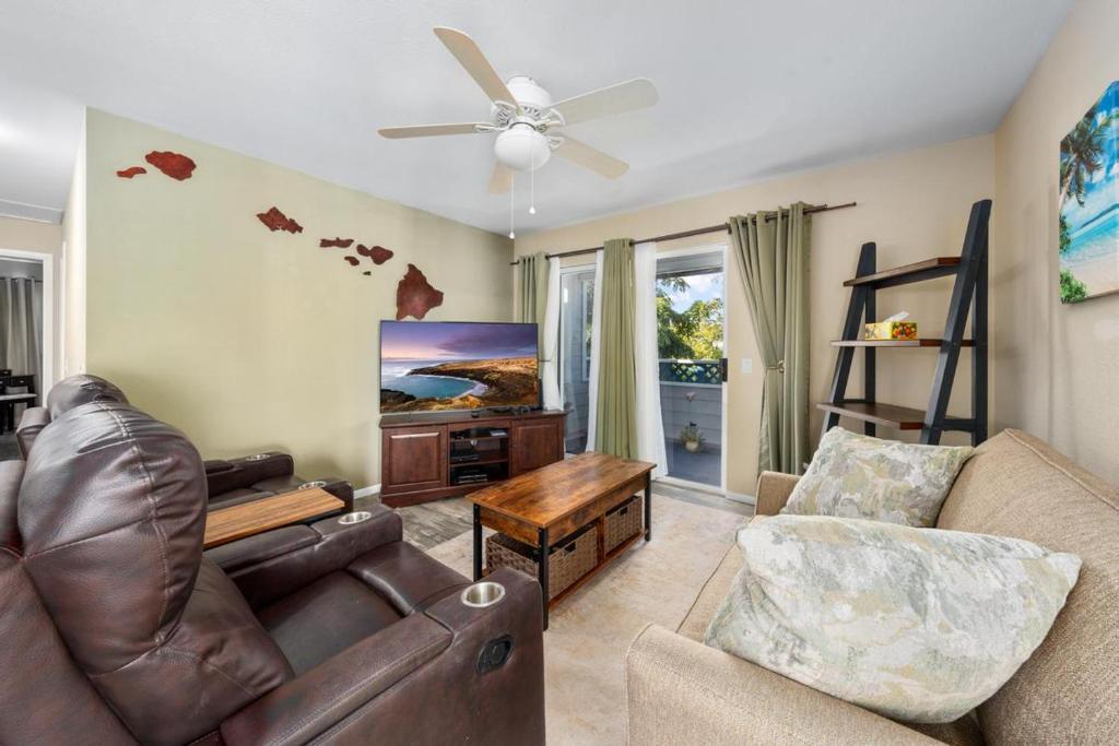 a living room with a couch and a ceiling fan at Big Island Fairway Terrace A-202 by Coldwell Banker Island Vacations in Waikoloa Village