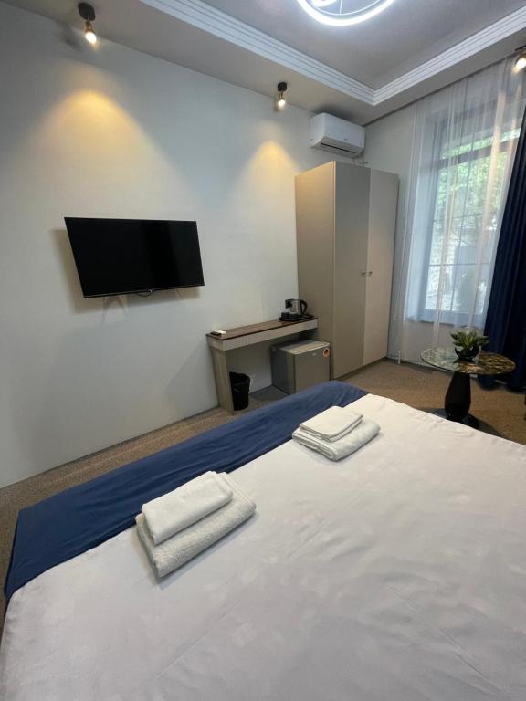 Postel nebo postele na pokoji v ubytování Zangu Hotel