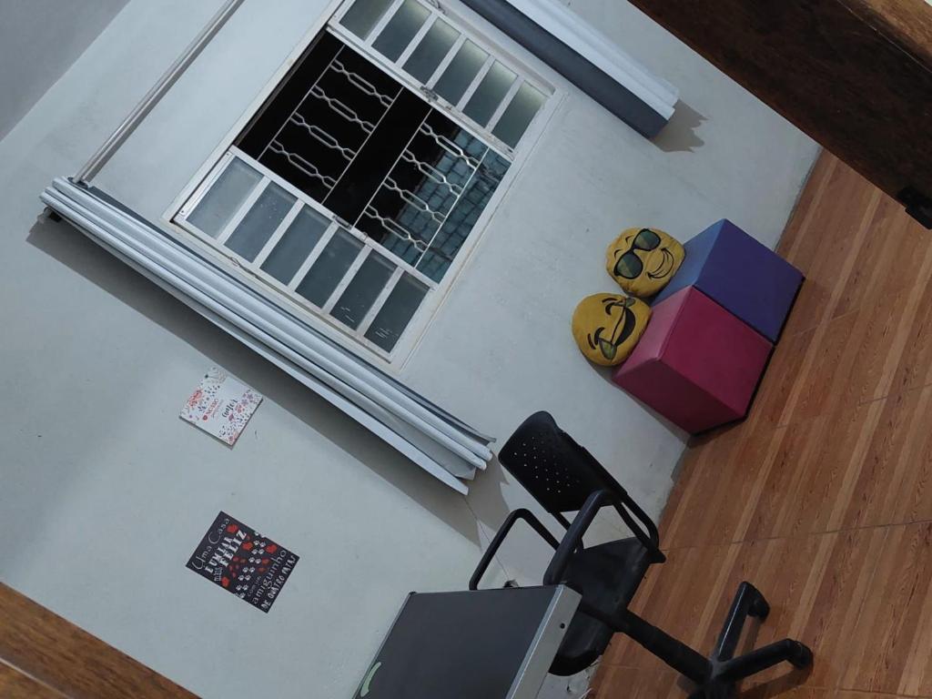 an overhead view of a room with a chair and a window at Sítio Rodrigues in Pedro Leopoldo