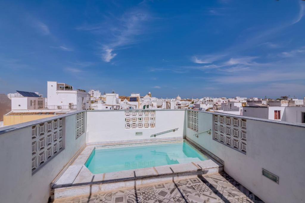 a swimming pool on the roof of a building at Patio Suite - by Enjoy your stay in Olhão