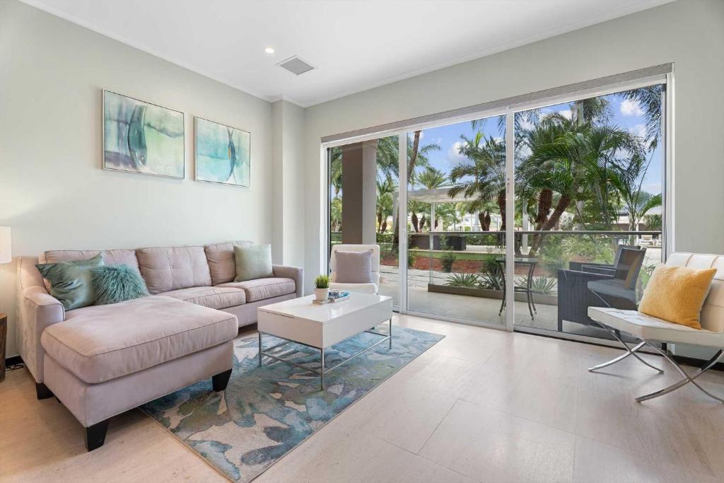 a living room with a couch and a table at Eagle Beach - Pearl Garden 2BR condo - LV103 in Palm-Eagle Beach