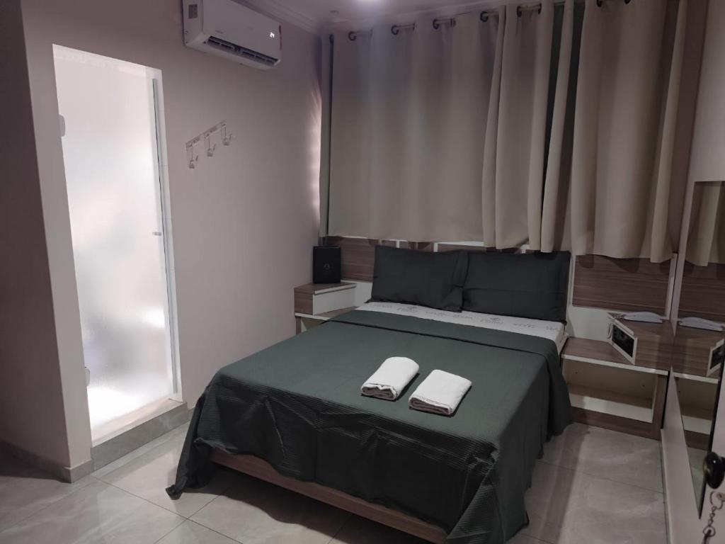 a bedroom with a bed with two towels on it at Hotel Prime Tatuapé - Próximo à Estação do Metrô Belém in Sao Paulo