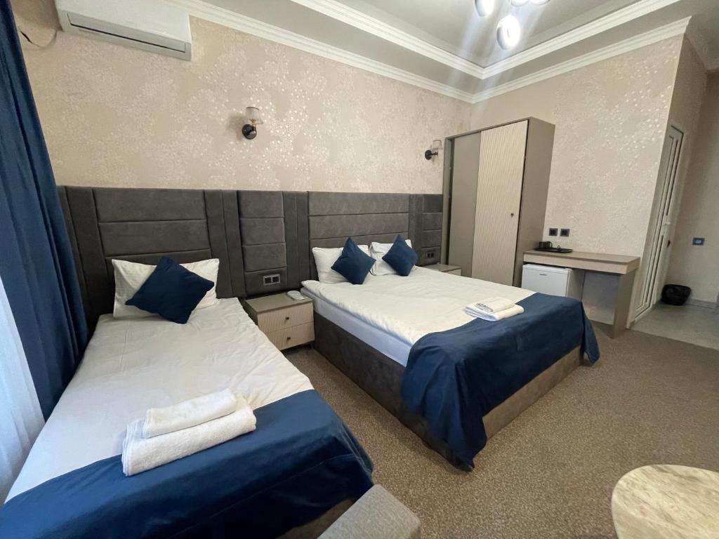 Postel nebo postele na pokoji v ubytování Zangu Hotel