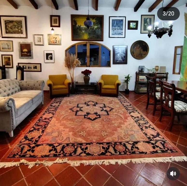 a living room with a couch and a rug at Casa Paula acosta santa marta in Gaira