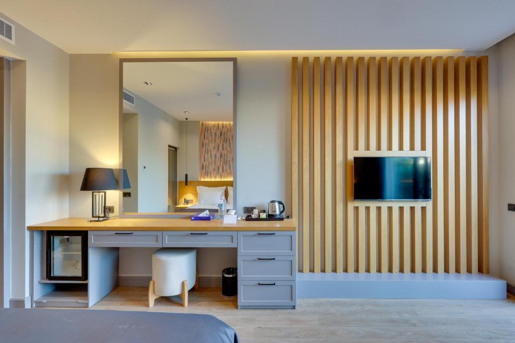 a desk in a room with a mirror at Celeste Bella Luxury Hotel & Spa in Ortakent