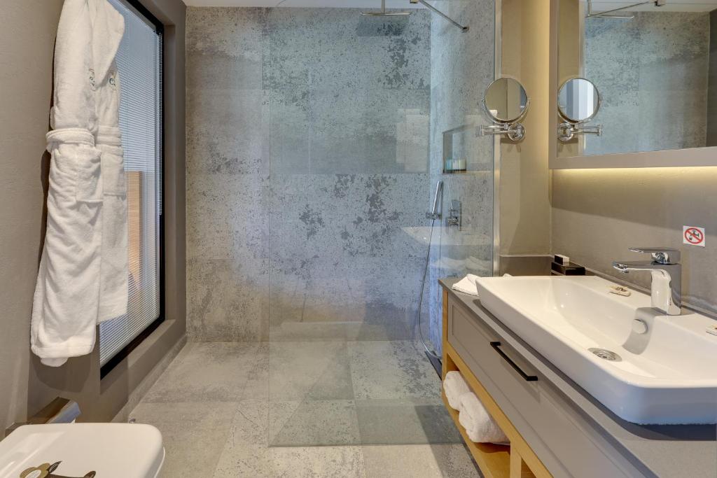 a bathroom with a sink and a shower at Celeste Bella Luxury Hotel & Spa in Ortakent