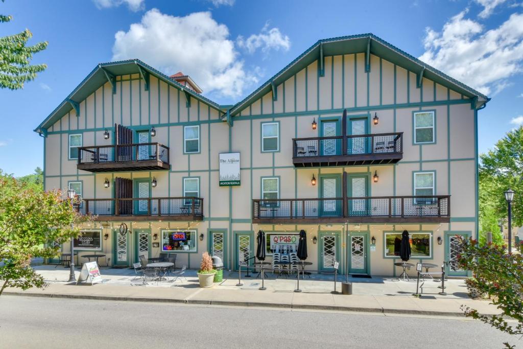 a large white building with windows and balconies at Steps to River and Shops Downtown Helen Retreat! in Helen