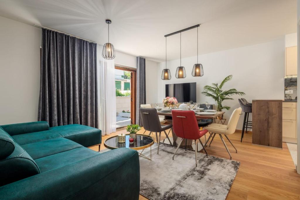a living room with a blue couch and a table at Mirela's golden luxury apartment in Split
