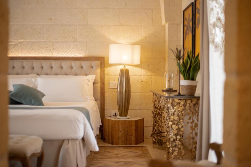 Postel nebo postele na pokoji v ubytování Masseriola Antiche Fogge by Apulia Hospitality