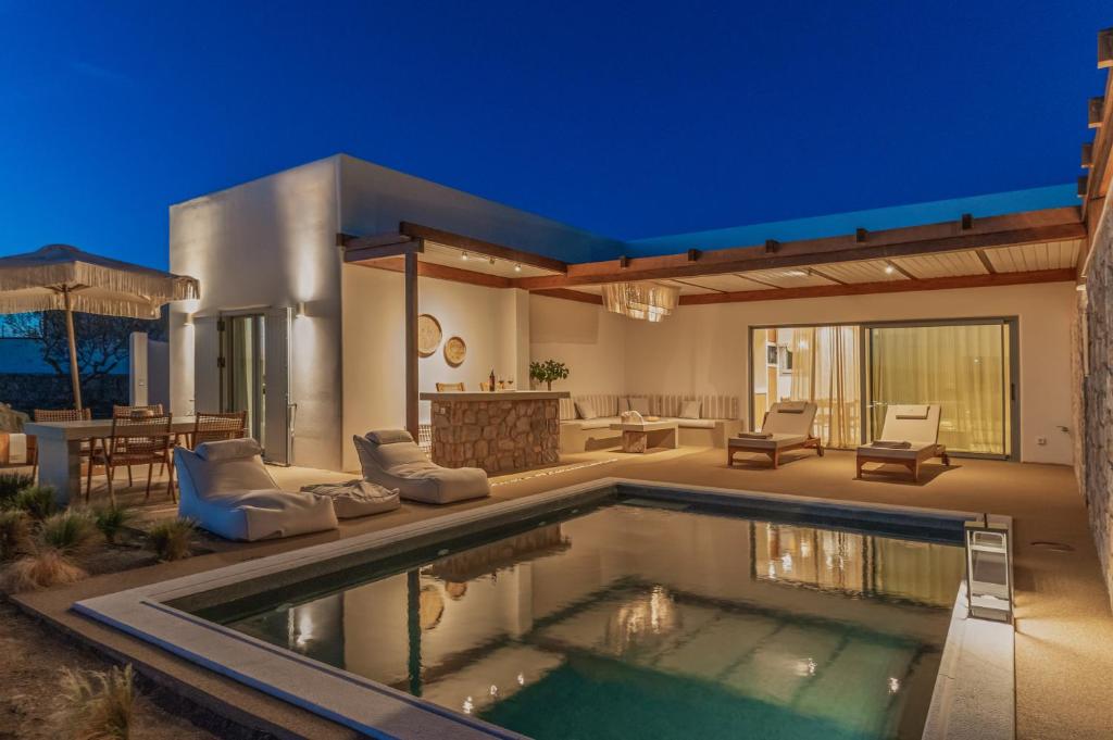 a house with a swimming pool in the yard at Adriana Luxury Villas in Adamantas