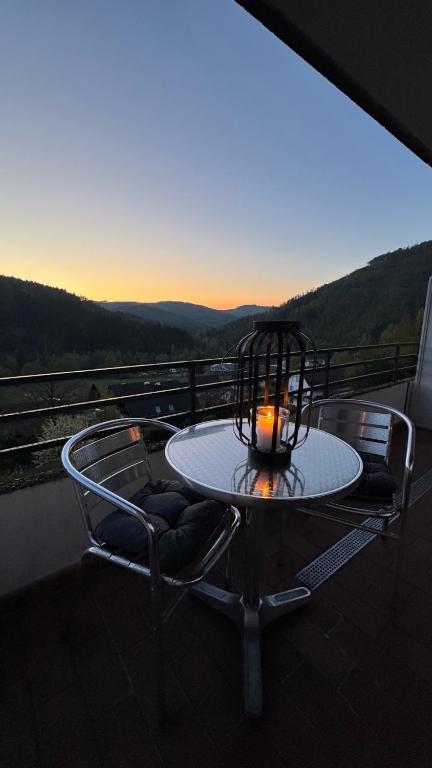 a candle sitting on a table on a balcony at Teufelsberg Panorama mit Sauna und Bergblick in Langelsheim