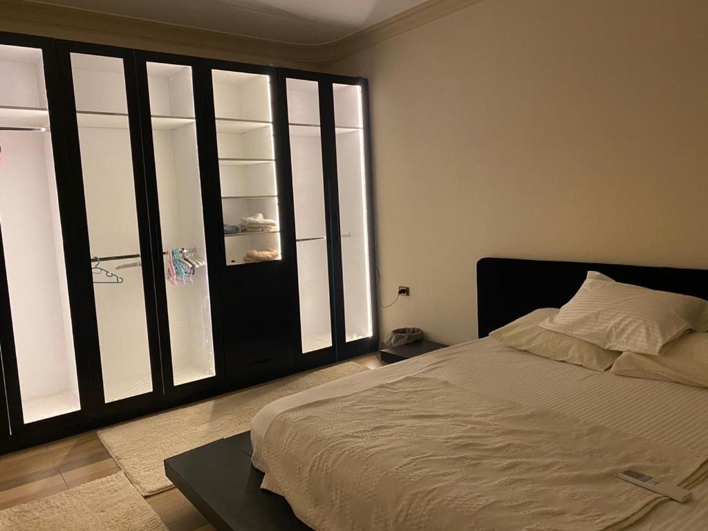 a bedroom with a bed and a large window at Villa In 5th Settlement in Cairo