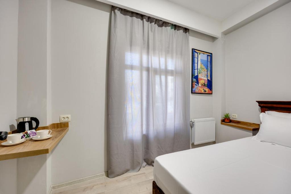 Postel nebo postele na pokoji v ubytování Regraph Hotel