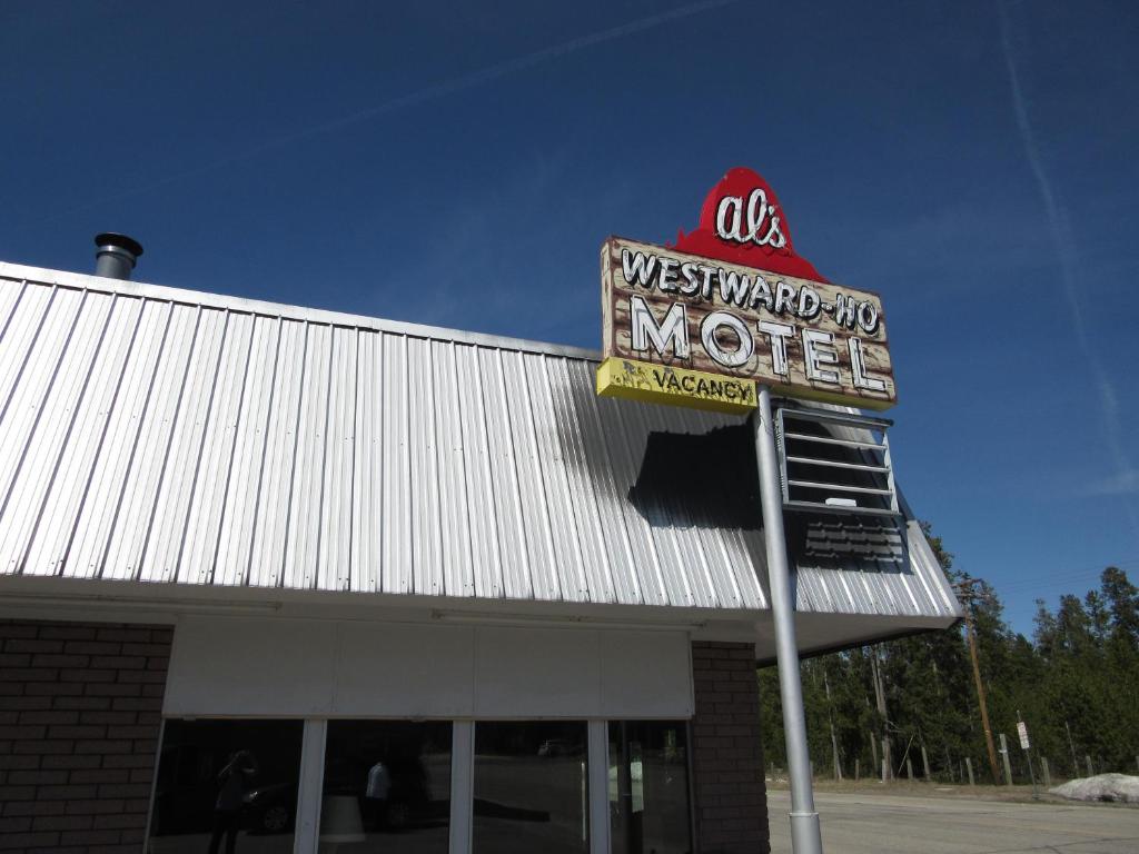 a sign for a westward mo motel on top of a building at Al's Westward Ho Motel in West Yellowstone