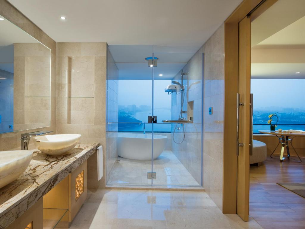 a bathroom with two sinks and a shower at White Swan Hotel in Guangzhou