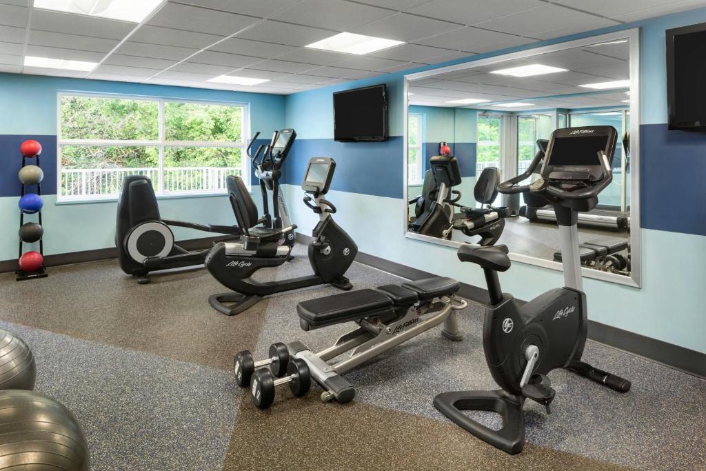 a gym with treadmills and exercise equipment in a room at Four Points by Sheraton Surrey in Surrey
